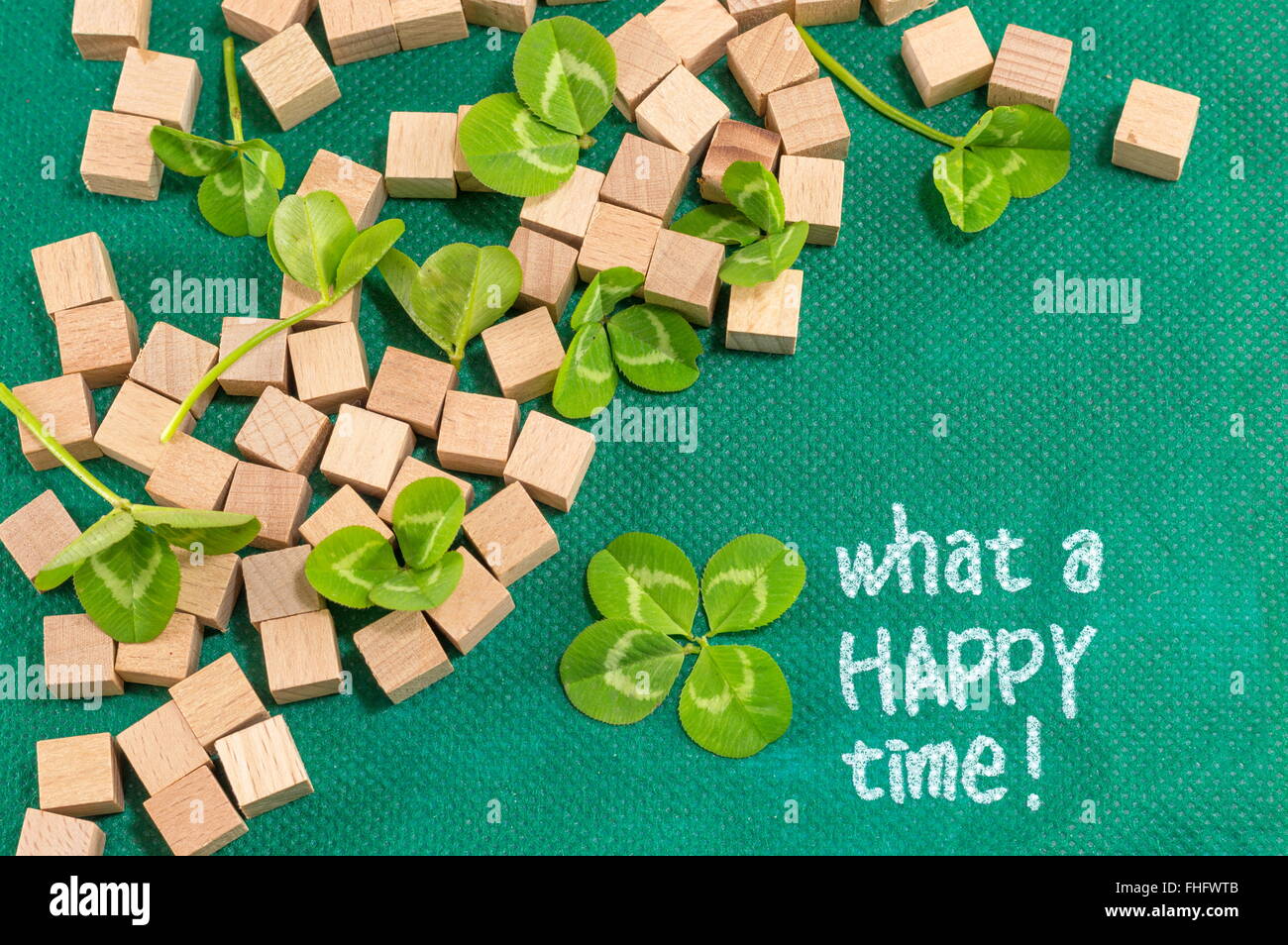 St. Patrick decoration with clover and small wooden cubes Stock Photo