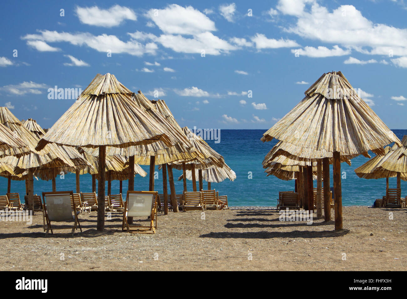 Summer beach with chairs and umbrellas in Montenegro Stock Photo