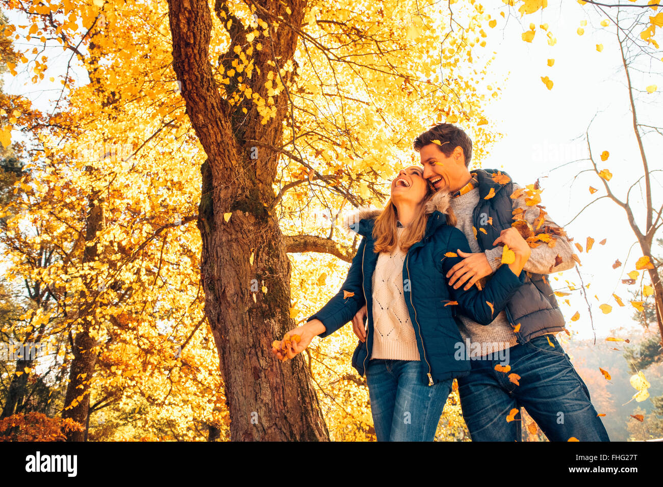 Happy couple having fun in autumn in a forest Stock Photo - Alamy