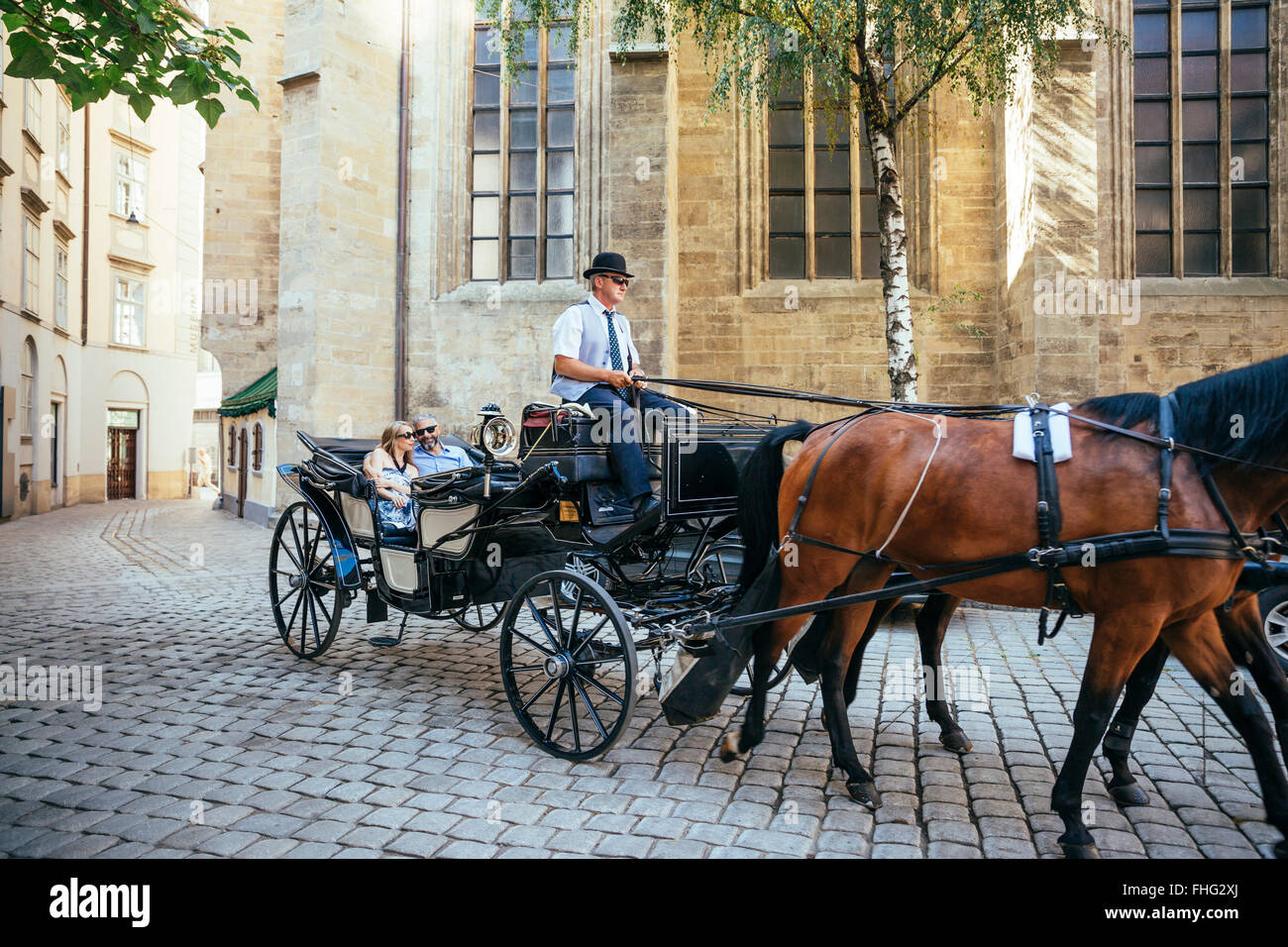 Austria, Vienna, tourists on sightseeing tour in a fiaker Stock Photo