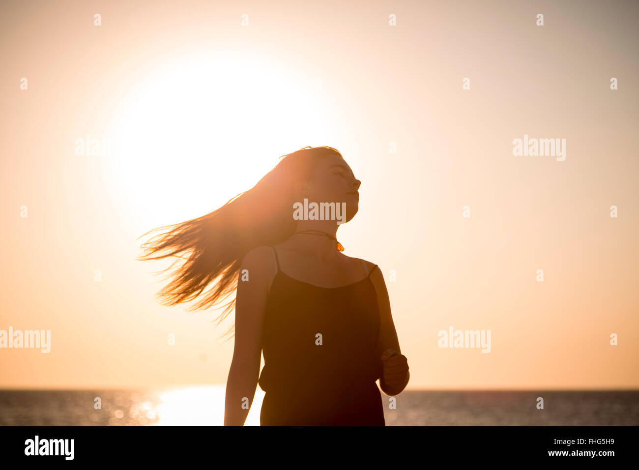 sunset and silhouette of a teenage girl in motion Stock Photo - Alamy