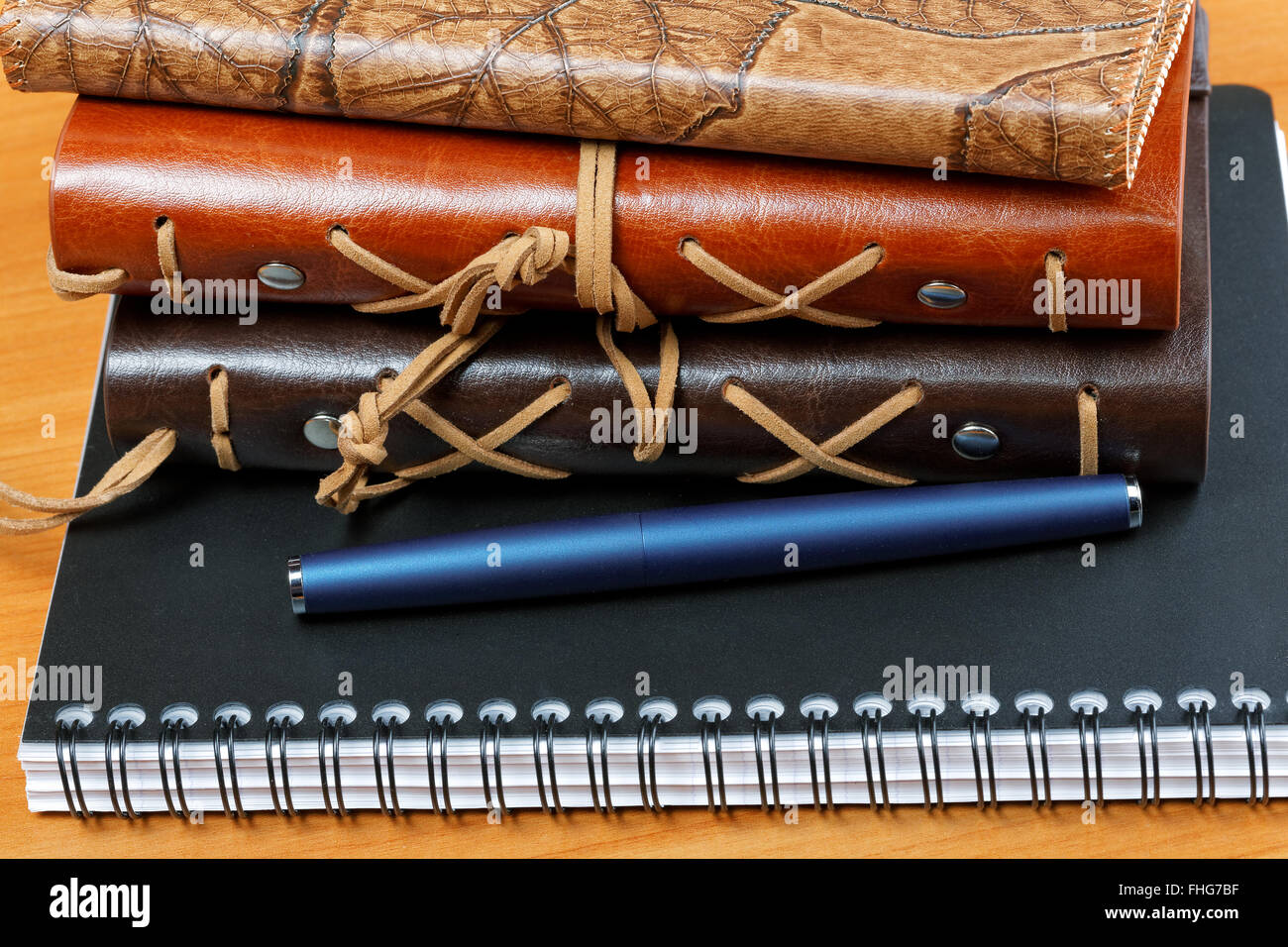 notebooks with leather cover and pen on the table Stock Photo - Alamy