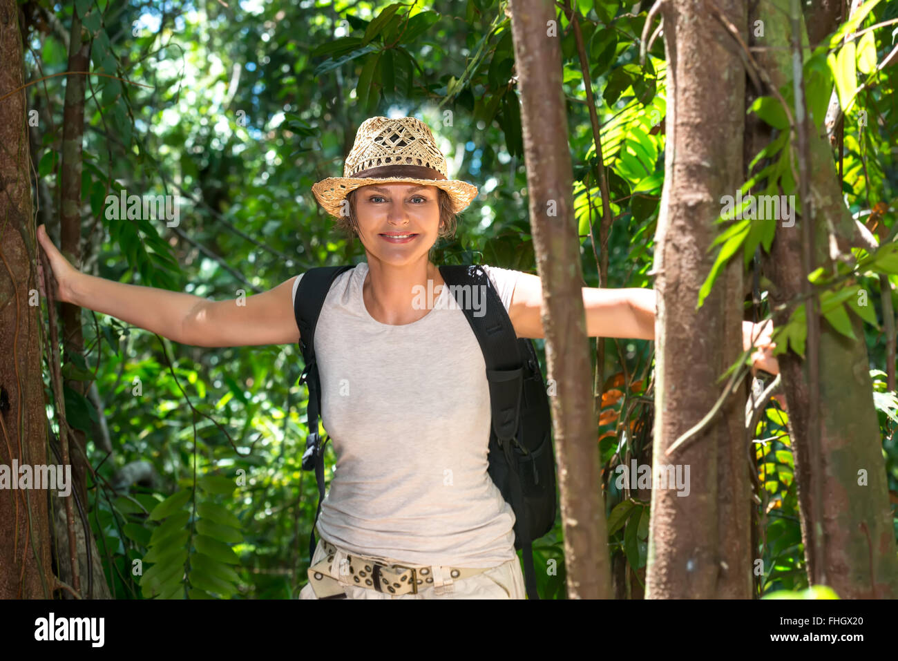 Middle aged woman hiking in tropical forest Stock Photo - Alamy