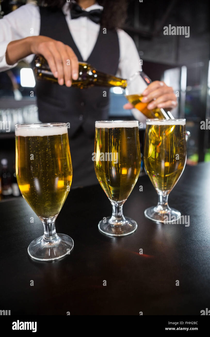 Three glasses of beer ready to serve on bar counter Stock Photo Alamy