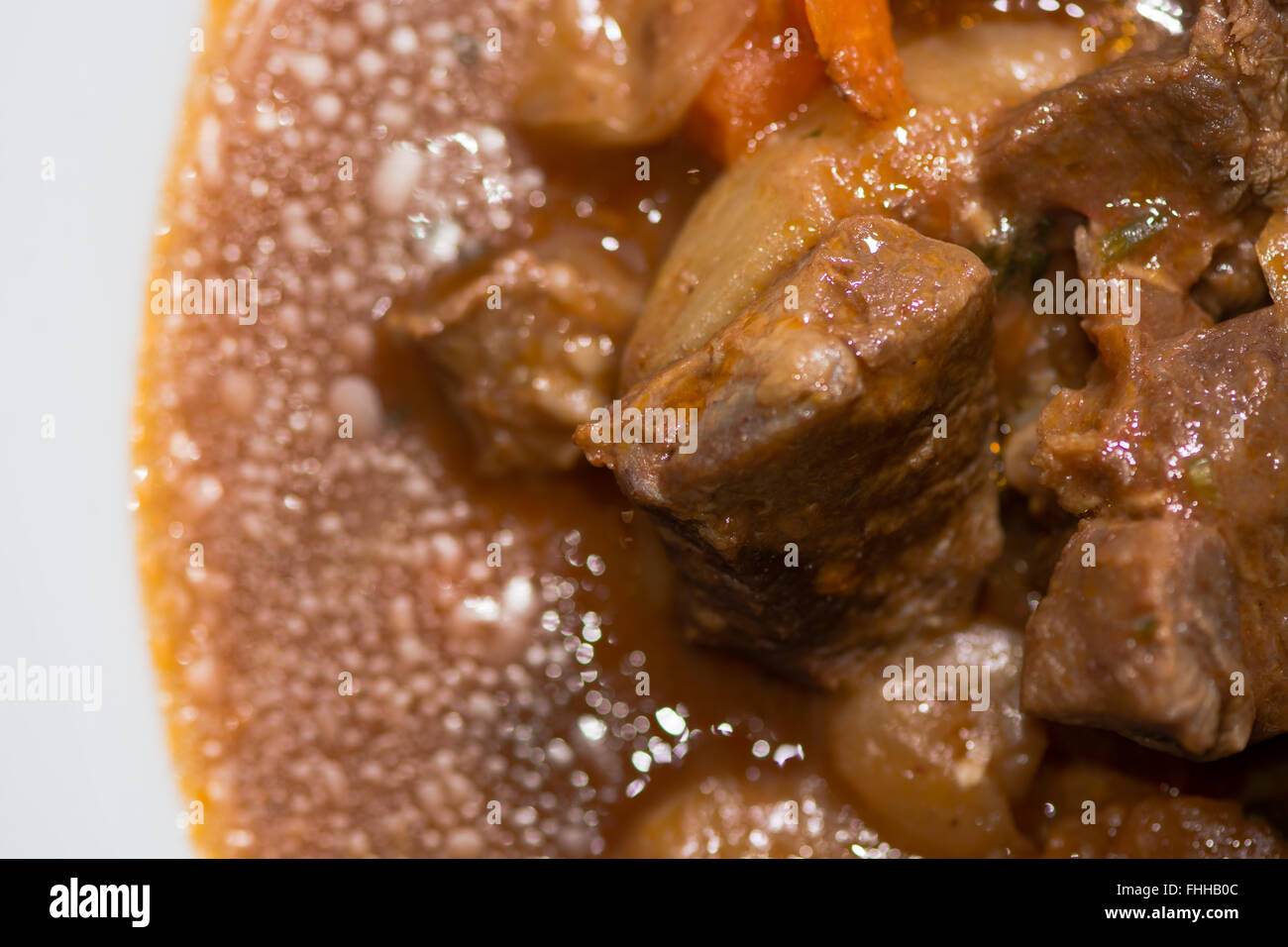 Lamb navarin section of plate from above. French spring stew with lamb and vegetables, prepared by a restaurant chef Stock Photo