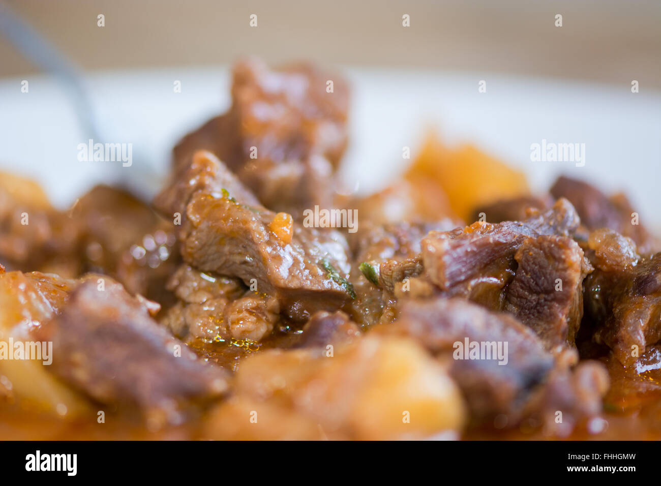 Lamb navarin detail on fork. French spring stew with lamb and vegetables, prepared by a restaurant chef Stock Photo