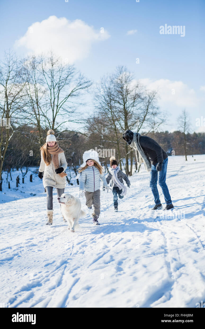 Family walking together in the snow Stock Photo - Alamy