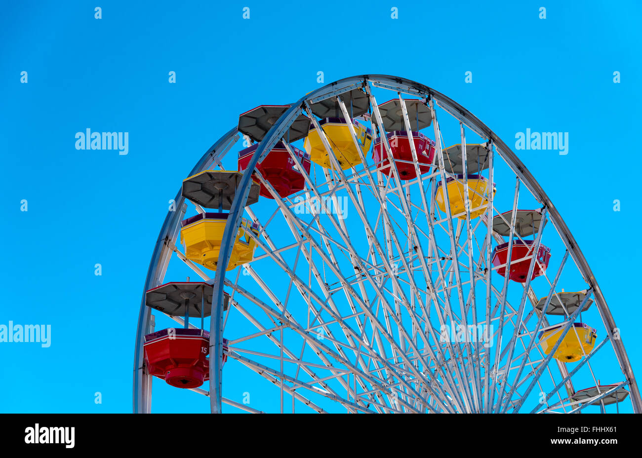 section of a ferris wheel against blue sky Stock Photo