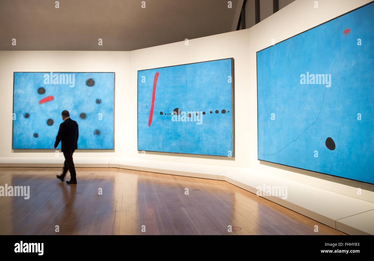 A visitor passing the paintings 'Blau I', 'Blau II' and 'Blau III' by Joan Miró, painted in 1961, at the Schirn art gallery in Frankfurt (Main), Germany, 25 February 2016. With the title 'Wandbilder, Weltenbilder' (lit. 'Wall pictures, world pictures'), roughly 50 works of the Catalan are on display, supposedly showing his renunciation of the traditional rules of painting. PHOTO: ALEXANDER HEINL/dpa Stock Photo