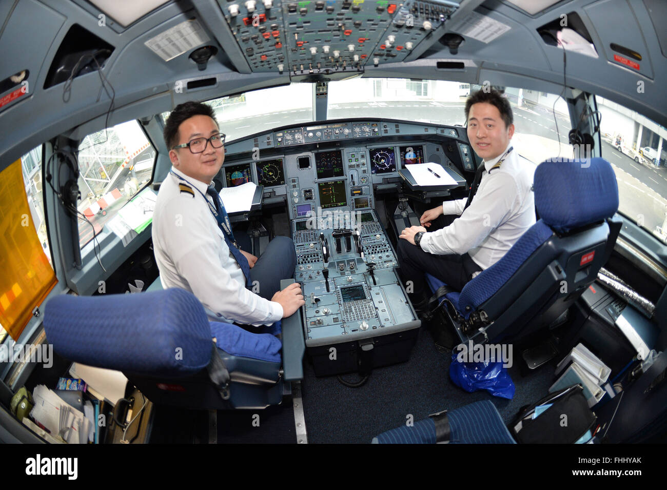 Prague, Czech Republic. 25th Feb, 2016. Ceremonial start of direct flights between Chengdu in China and Prague took place at the Vaclav Havel Airport in Prague, Czech Republic, February 25, 2016. Pictured from left: captain Ji Dong Ye and first officer Xu Rui in the cockpit of an Airbus A330-200. © Michal Dolezal/CTK Photo/Alamy Live News Stock Photo