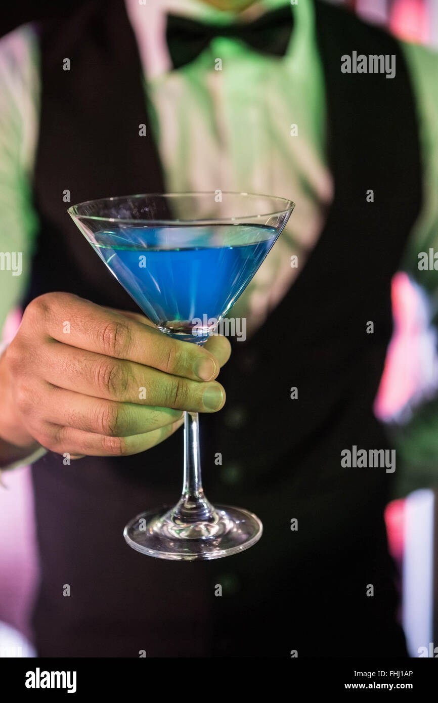 Close-up of bartender serving glass of cocktail Stock Photo