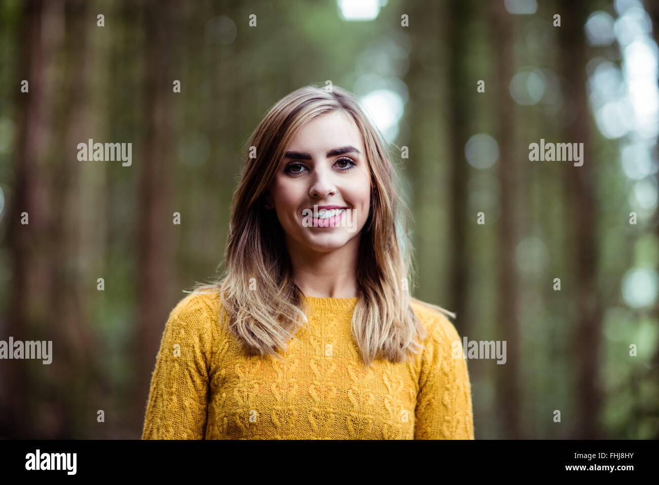 Pretty blonde woman smiling at camera Stock Photo - Alamy