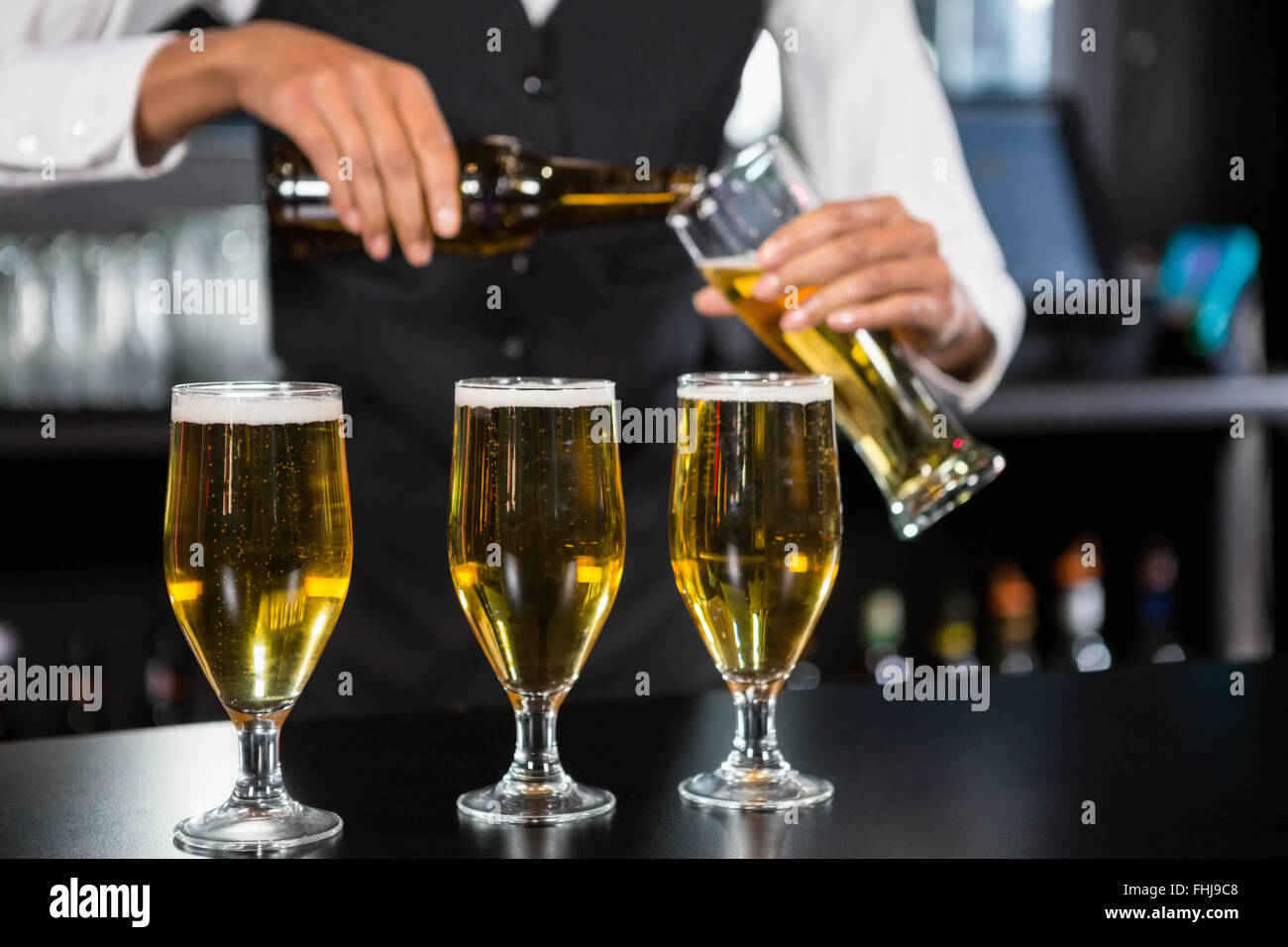 Three glasses of beer ready to serve on bar counter Stock Photo Alamy