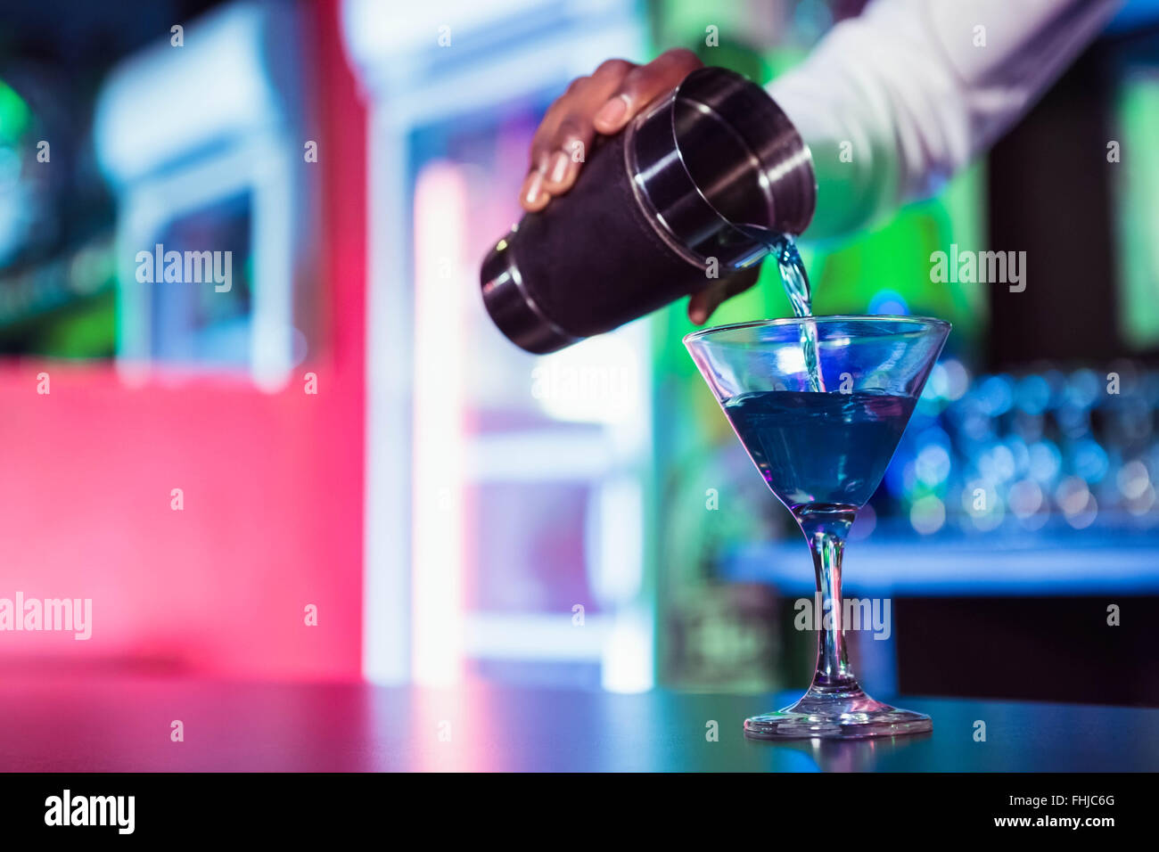 Bartender pouring cocktail from shaker Stock Photo Alamy