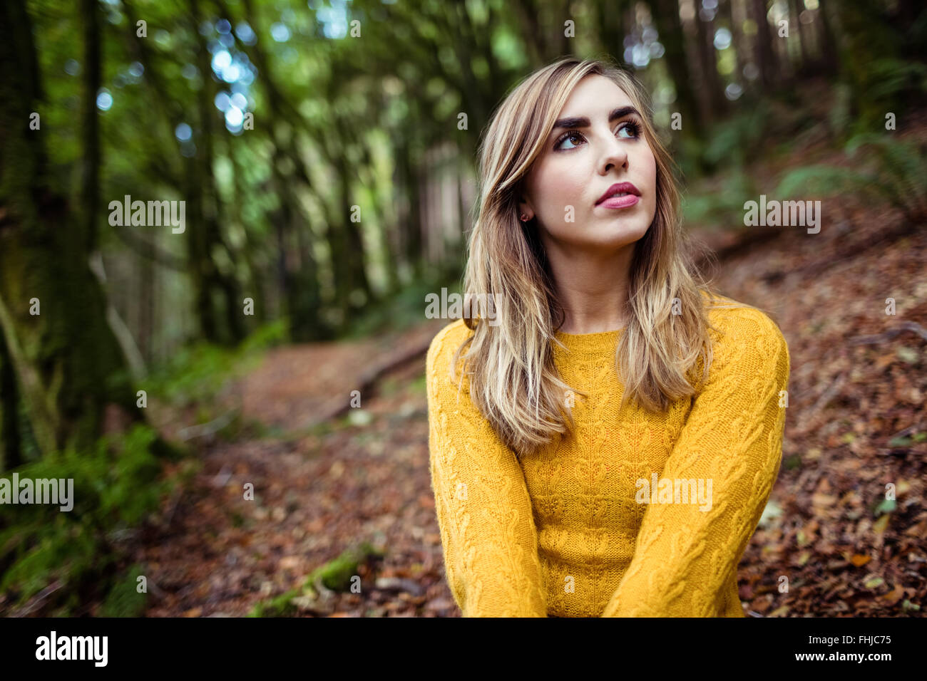 Pretty blonde woman day dreaming Stock Photo