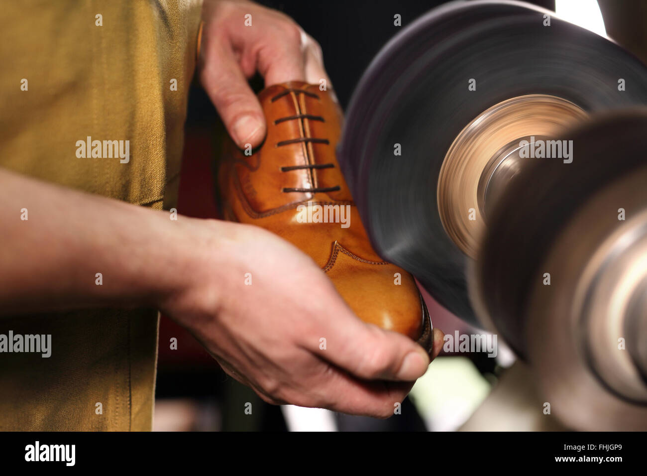 Polishing shoes. Polisher cobbler polishes on brown shoes. Classic men