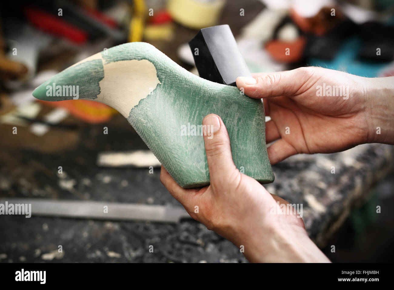 Punch skin for shoes. shoemaker makes chisel holes in the skin grain