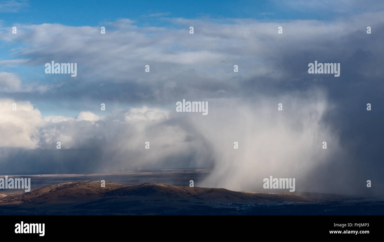 Clouds and Snowstorm over hills Stock Photo