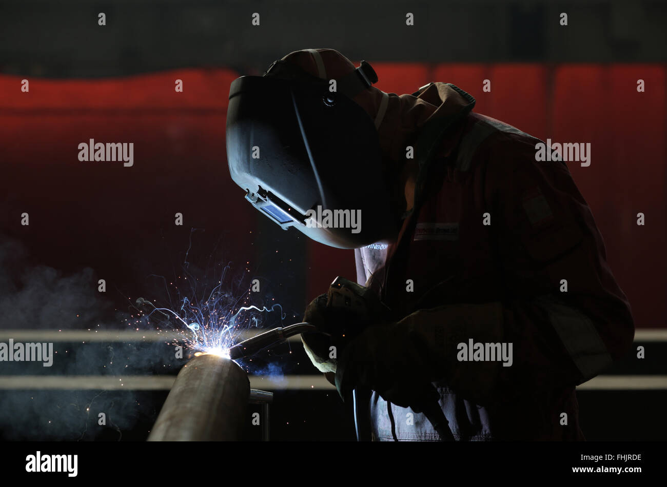 A welder MIG welding at a factory in Stockton-On-Tees, UK. Stock Photo