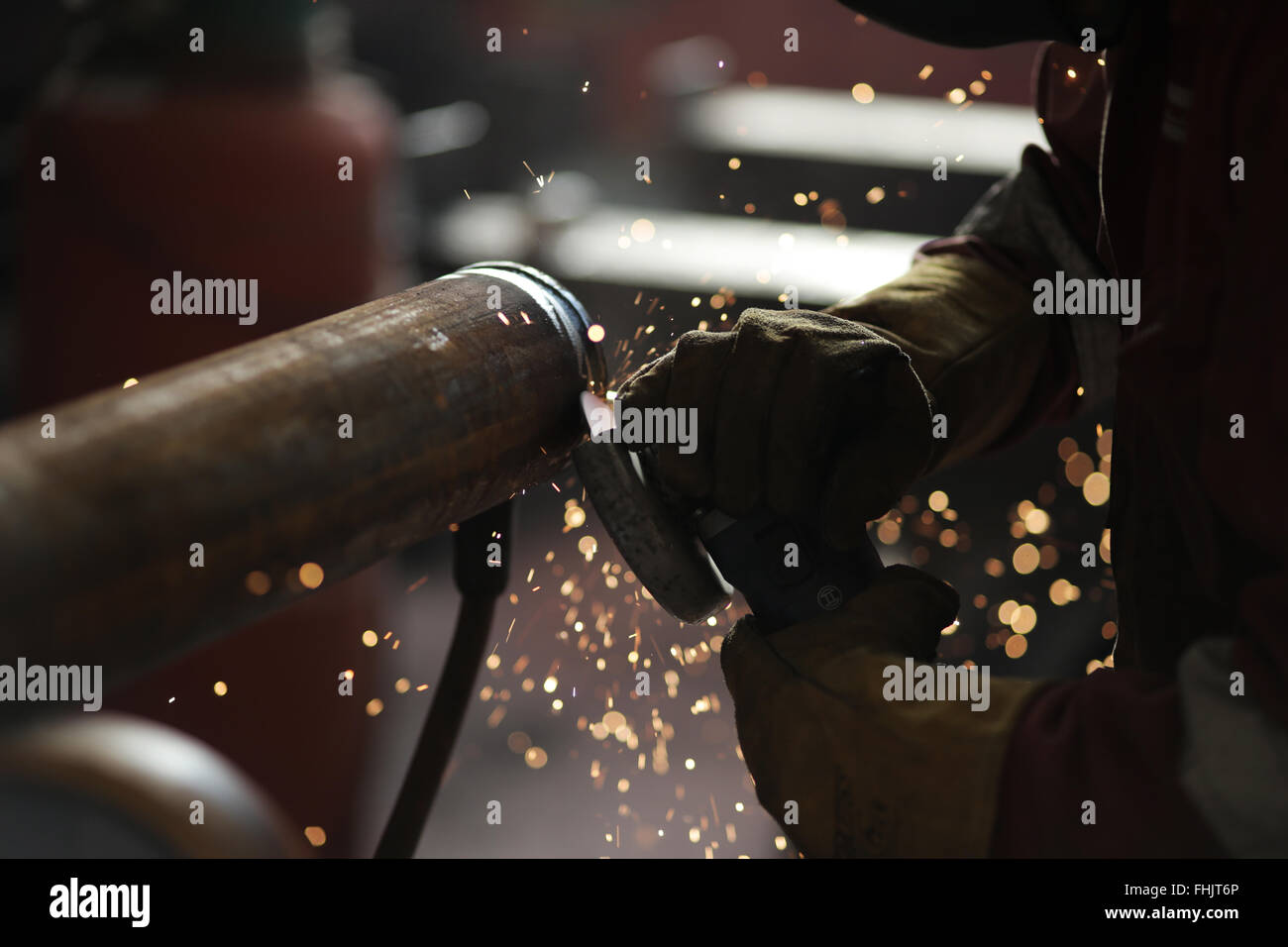 An engineer grinding a MIG weld at a factory in Stockton-On-Tees, UK. Stock Photo