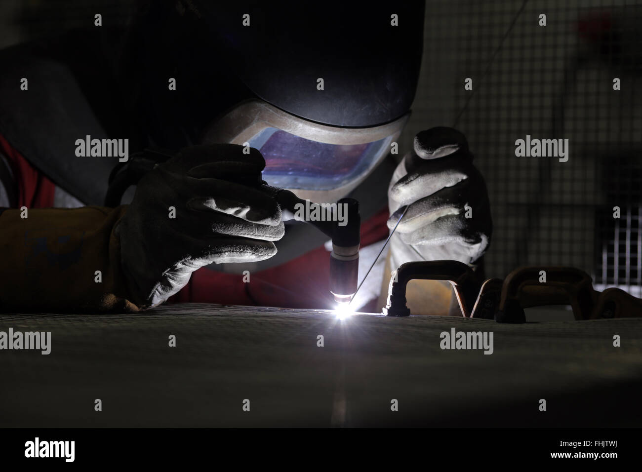 A welder welding aluminium at a factory in Stockton-On-Tees, UK. Stock Photo