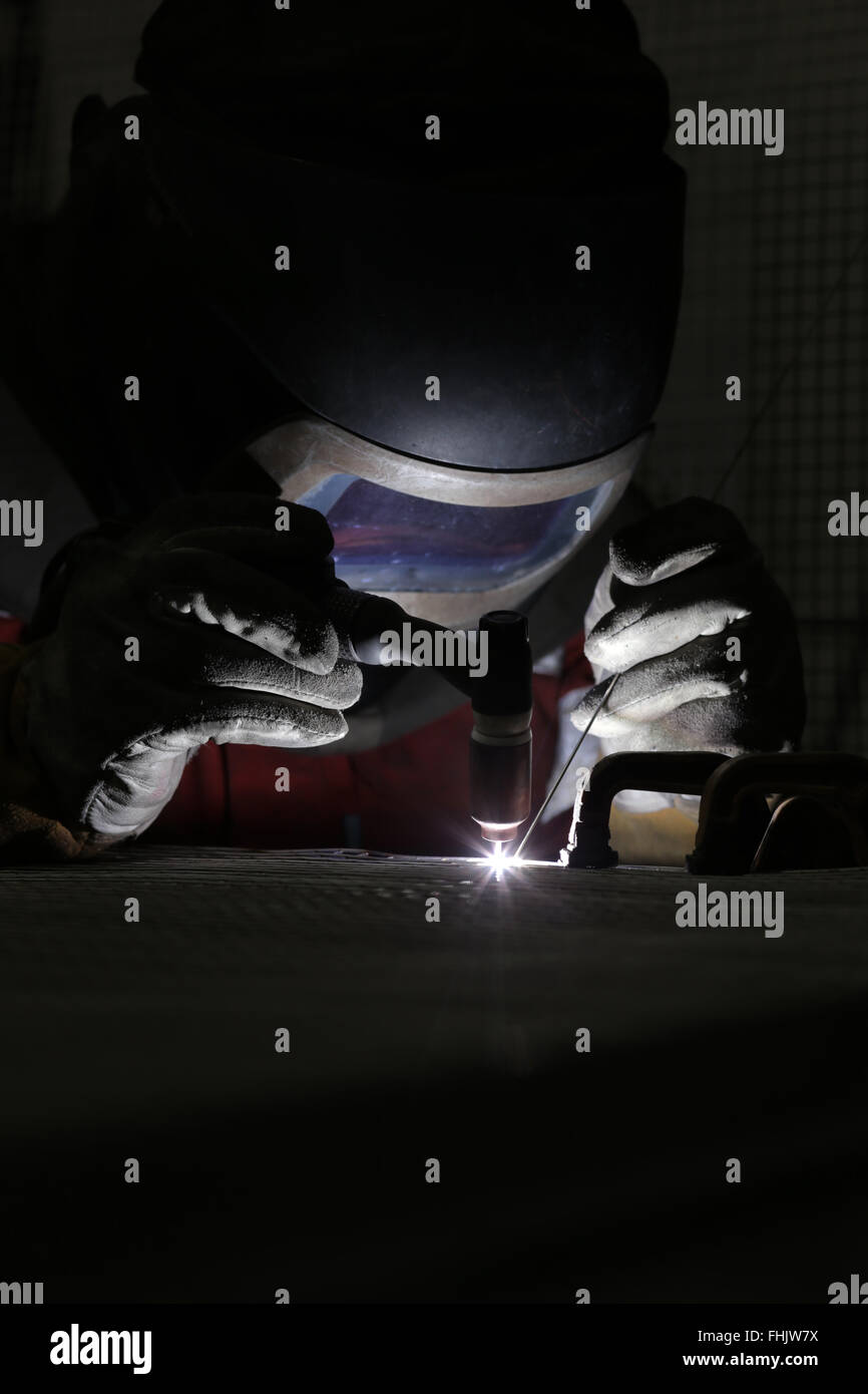 A welder welding aluminium at a factory in Stockton-On-Tees, UK. Stock Photo