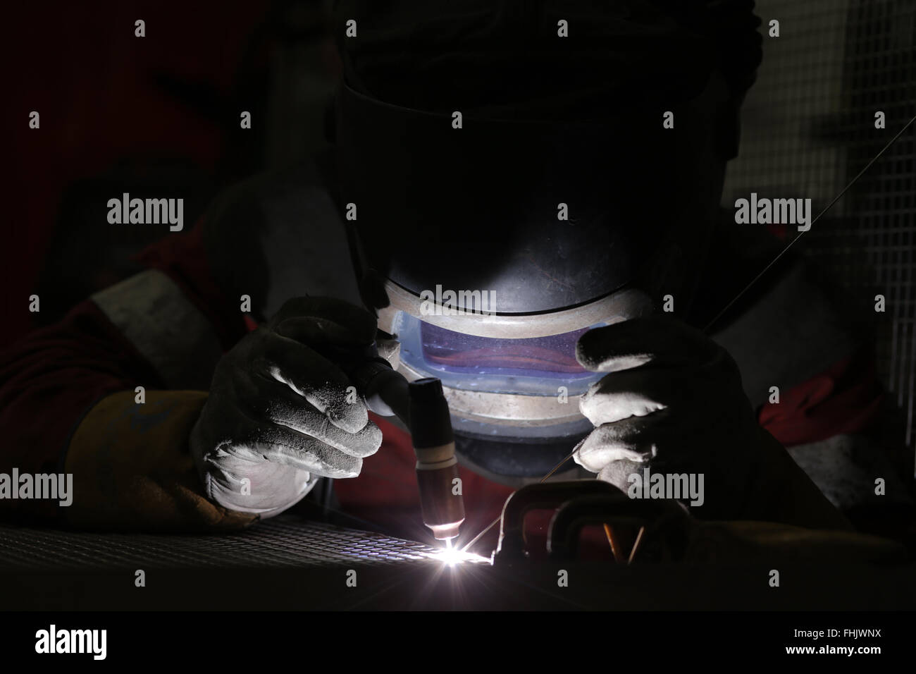 A welder welding aluminium at a factory in Stockton-On-Tees, UK. Stock Photo