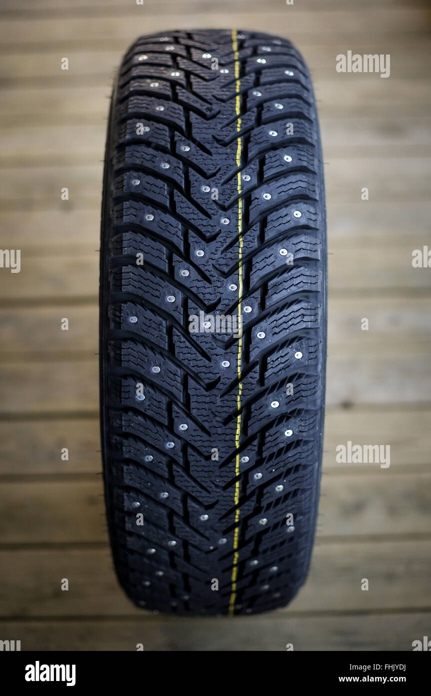 Studded tire on a gray background Stock Photo Alamy