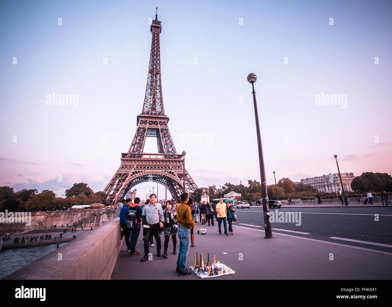 Paris, France - October 9, 2014:  Seen here is a street scene along the Pont d'Iéna bridge towards the Eiffel Tower at sunset. P Stock Photo