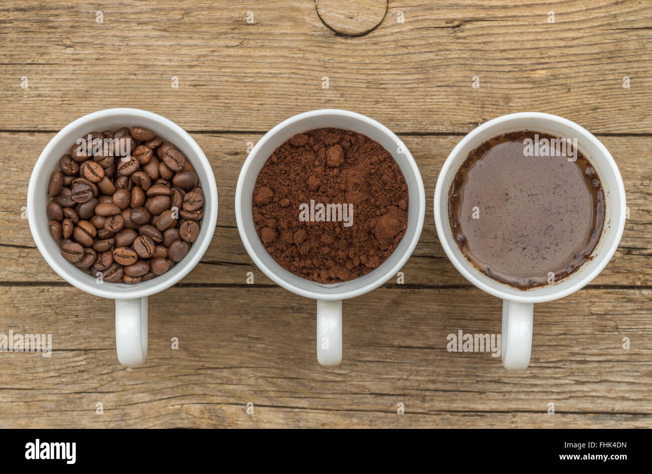 Three cups of different stages of preparing coffee, groud, bean, liquid Stock Photo