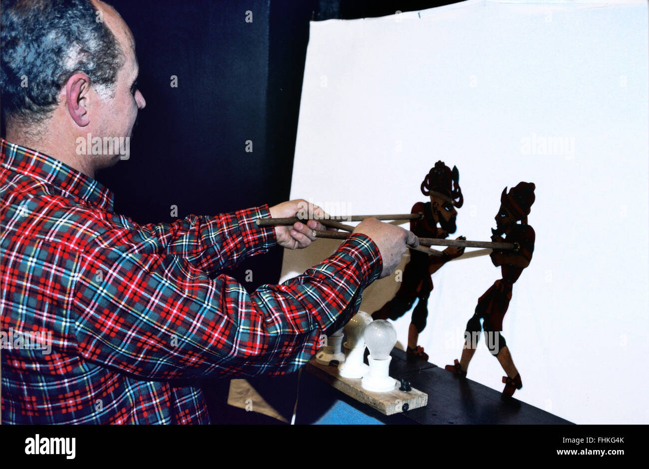 Puppeteer Manipulating Karagöz and Hacivat Shadow Puppets in the Traditional Turkish Shadow Play (a Sort of Turkish punch and Judy) Stock Photo