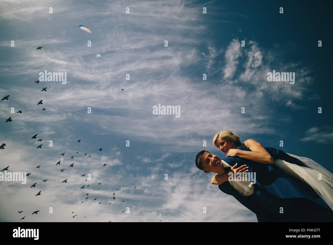 bride and groom on the background of sky Stock Photo - Alamy