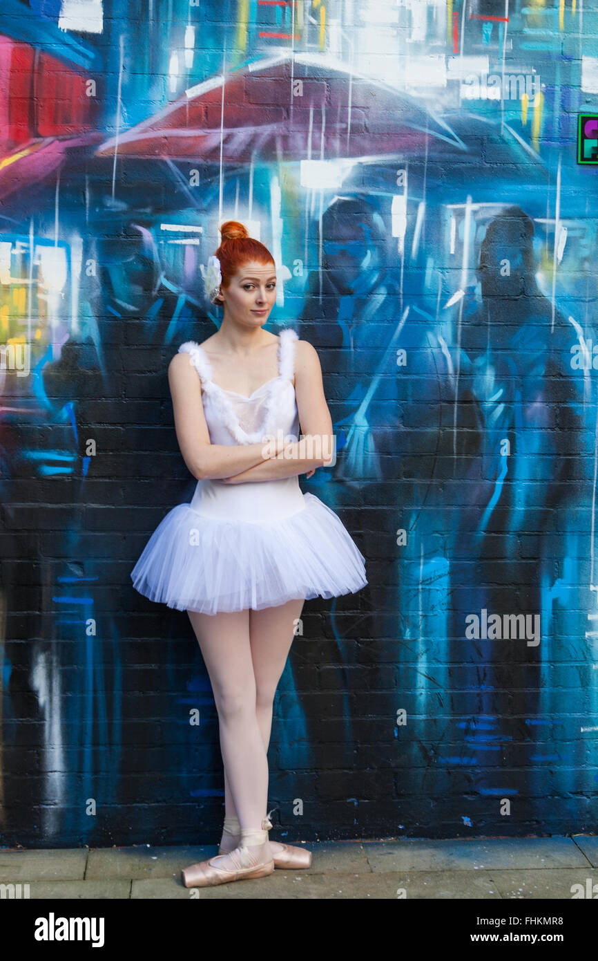 Ballerina in an urban environment. In front of graffiti by Dan Kitchener (Dank) at Custard Factory, Birmingham, UK Stock Photo