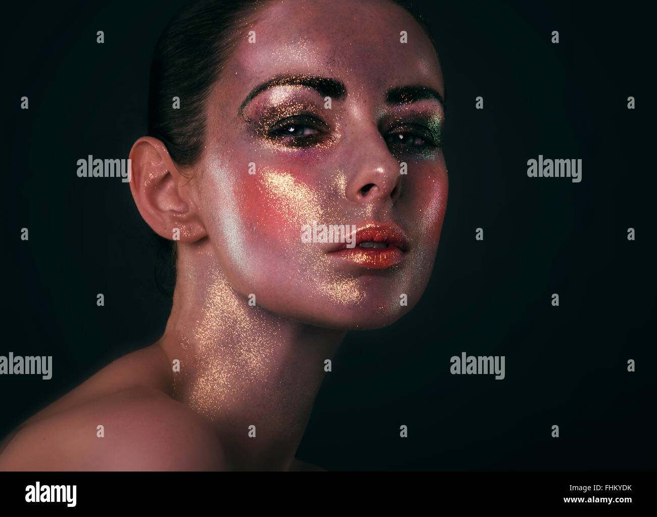 Fashion model with glitter make up covering whole face, lots of sheen and sparkle Stock Photo