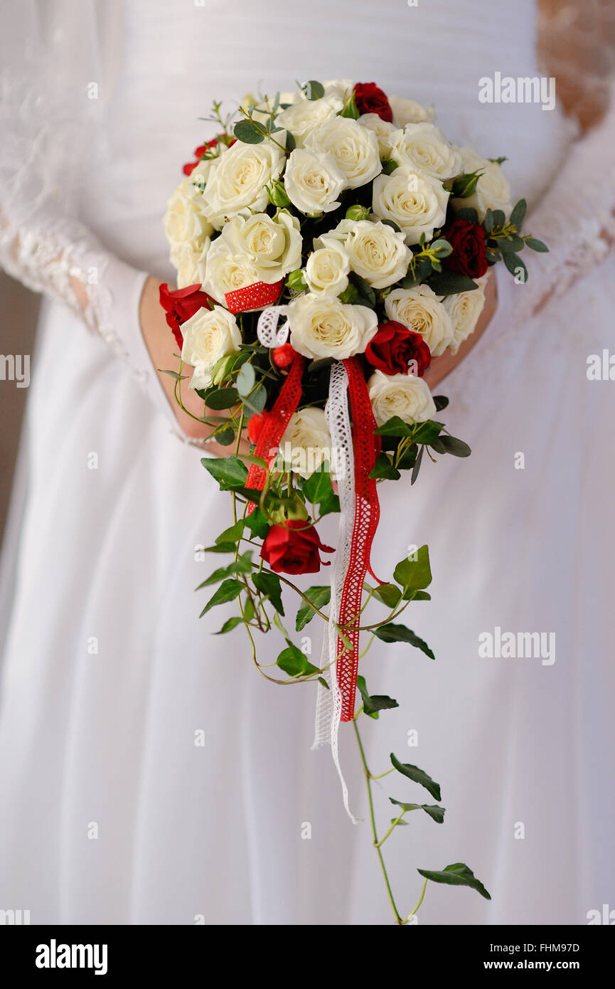 Beautiful wedding bouquet in hands of the bride Stock Photo