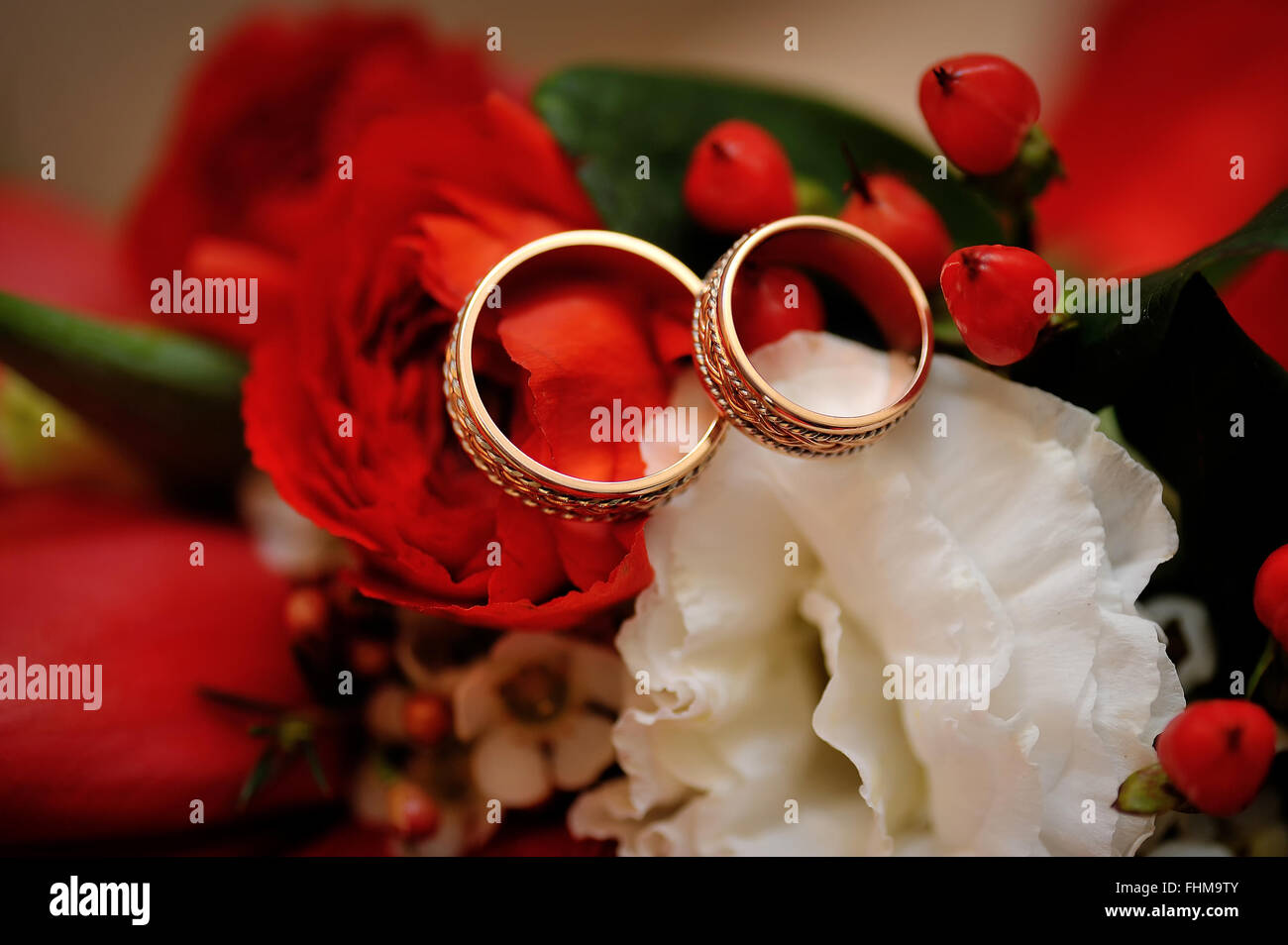 gold wedding rings on a wedding bouquet close up Stock Photo