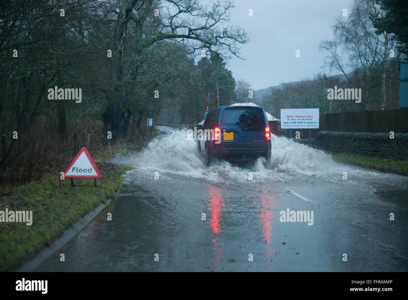 A 4x4 car driving through a flooded road, in Blair Atholl, Perthshire