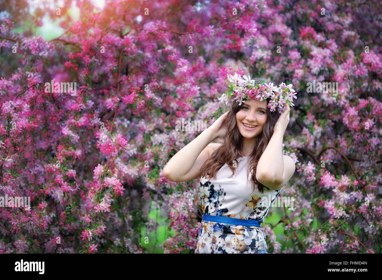 Beautiful girl outdoors spring portrait, young woman with flowers in green park, spring concept. cheerful teenager walking outdoor. series in portfolio Stock Photo