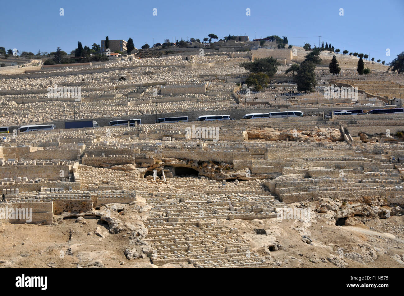 Tour buses and tombs in the Jewish cemetery of the  Mount of Olives, Jerusalem, Israel Stock Photo