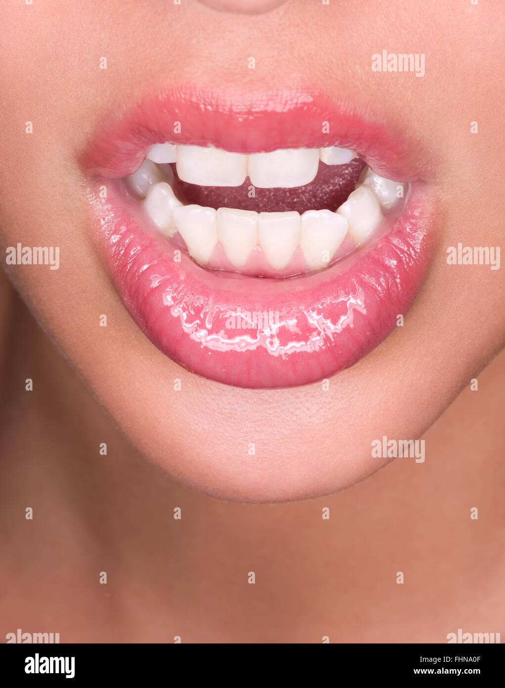 Close up of a woman wear pink lip gloss Stock Photo