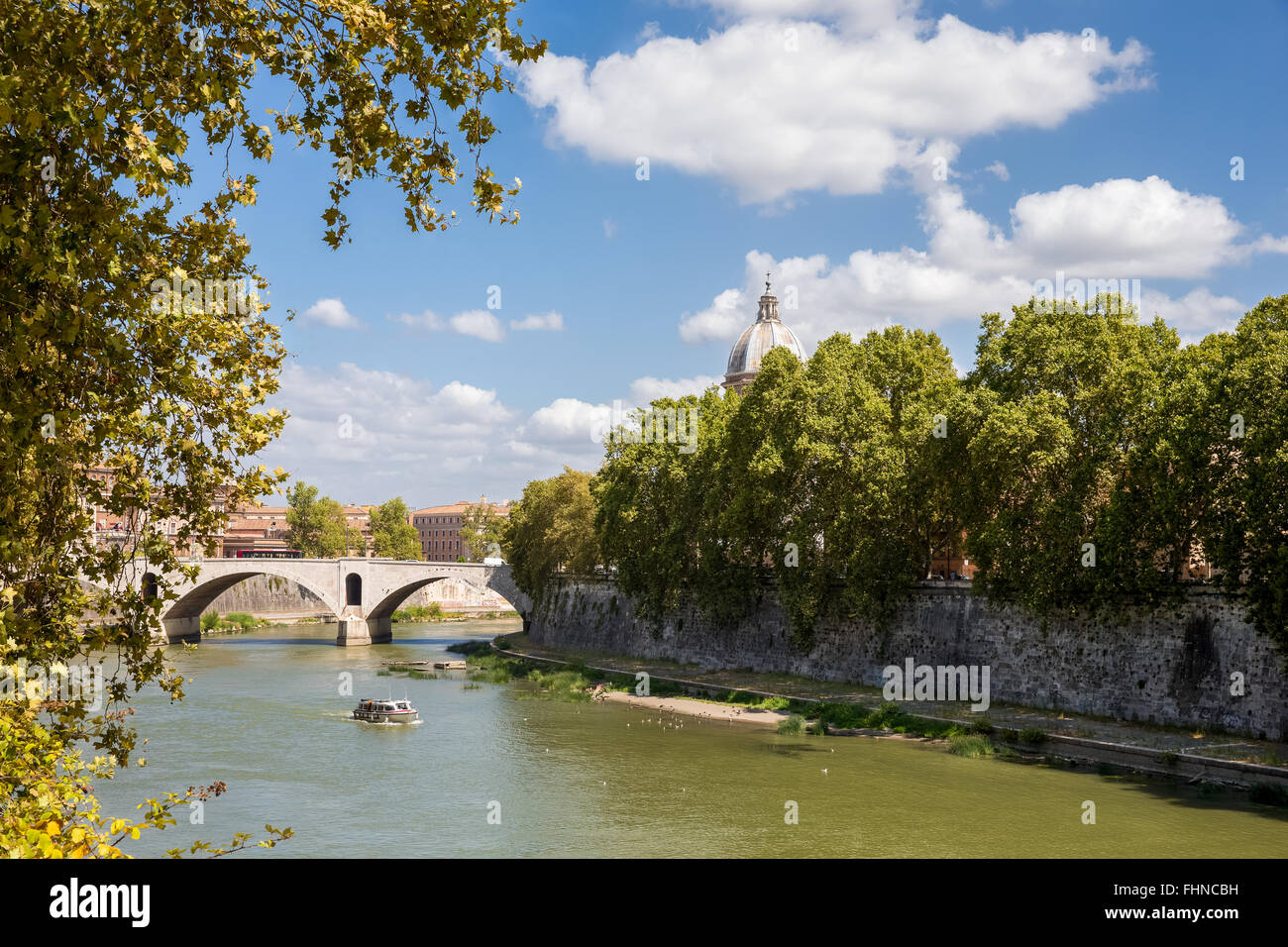 View of the Tiber River (Fiume Tevere) in Rome.  Looking north and showing the walking path at the river's edge. Stock Photo