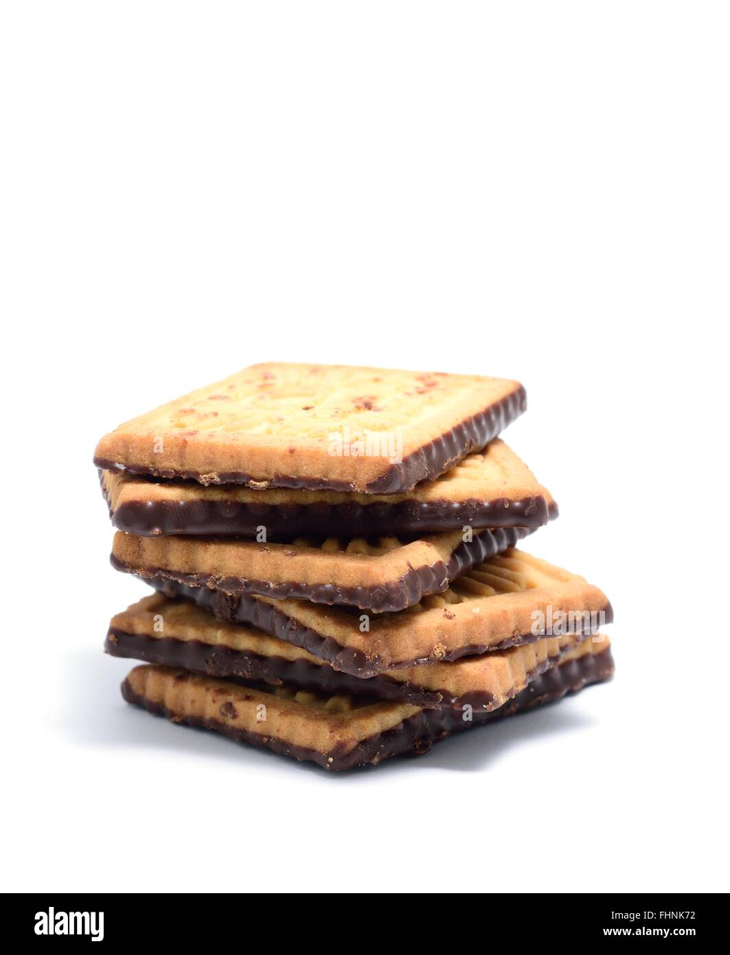 Stack of butter cookies with dark chocolate topping on a white background. Stock Photo