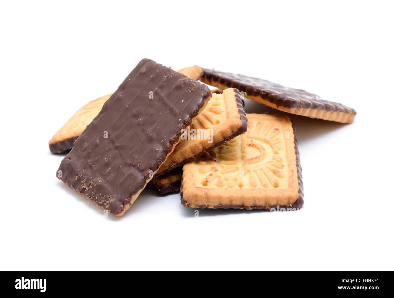 Stack of butter cookies with dark chocolate topping on a white background. Stock Photo