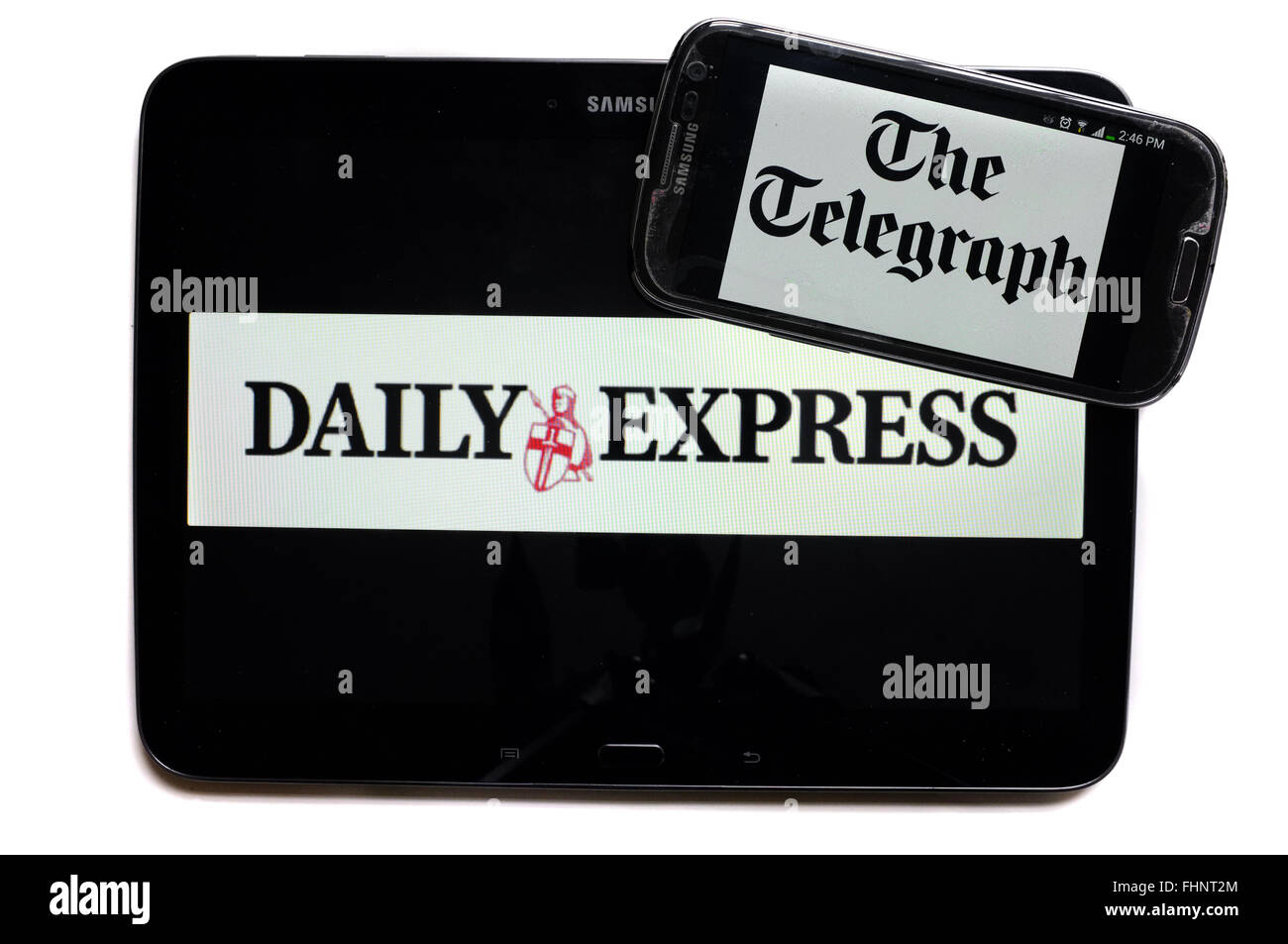 The logos of the Daily Express and The Telegraph newspapers displayed on the screens of a tablet and a smartphone. Stock Photo