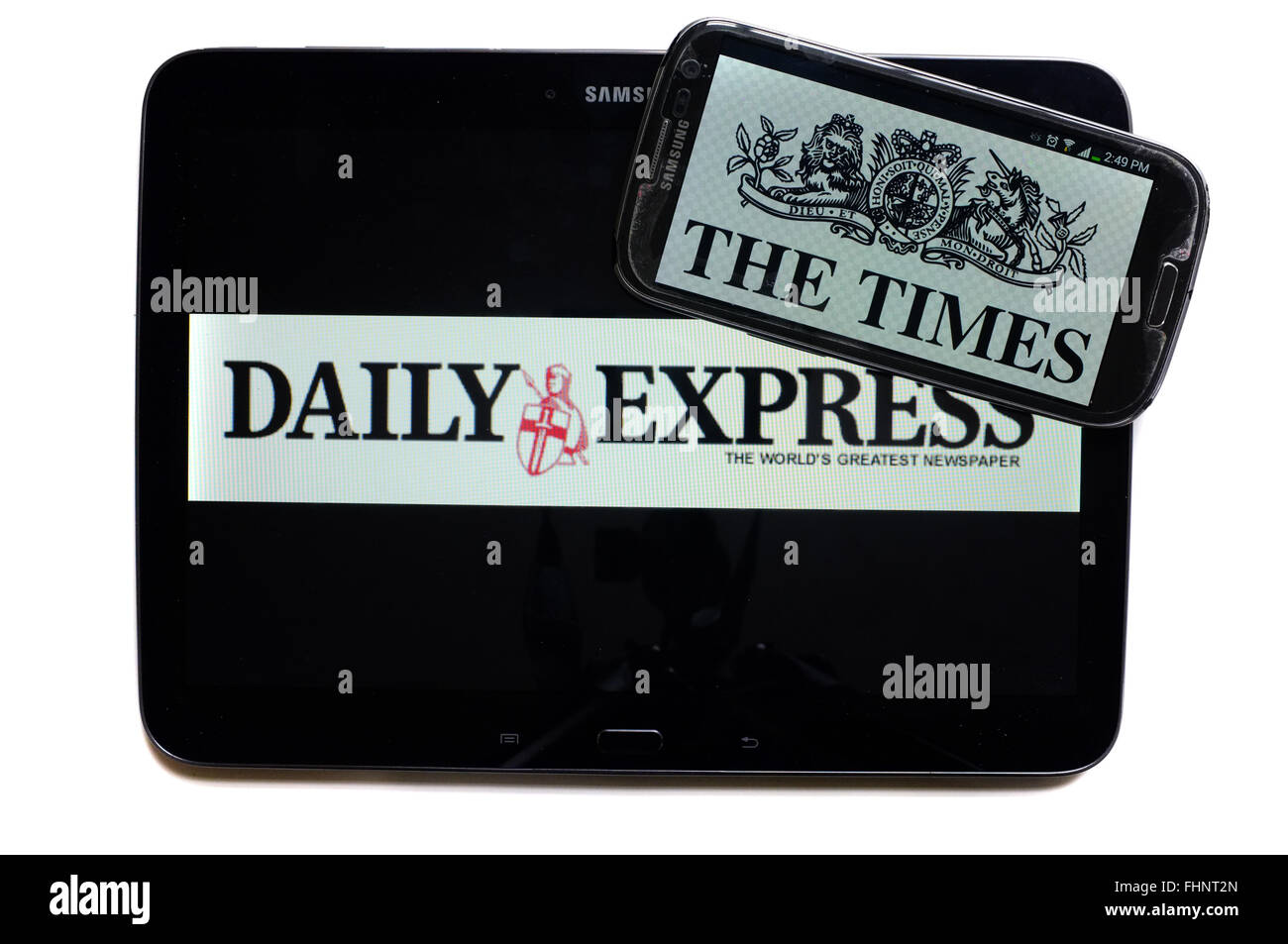The logos of the Daily Express and The Times newspapers displayed on the screens of a tablet and a smartphone. Stock Photo