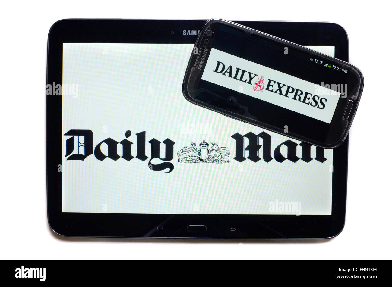 The logos of the Daily Mail and the Daily Express newspapers displayed on the screens of a tablet and a smartphone. Stock Photo
