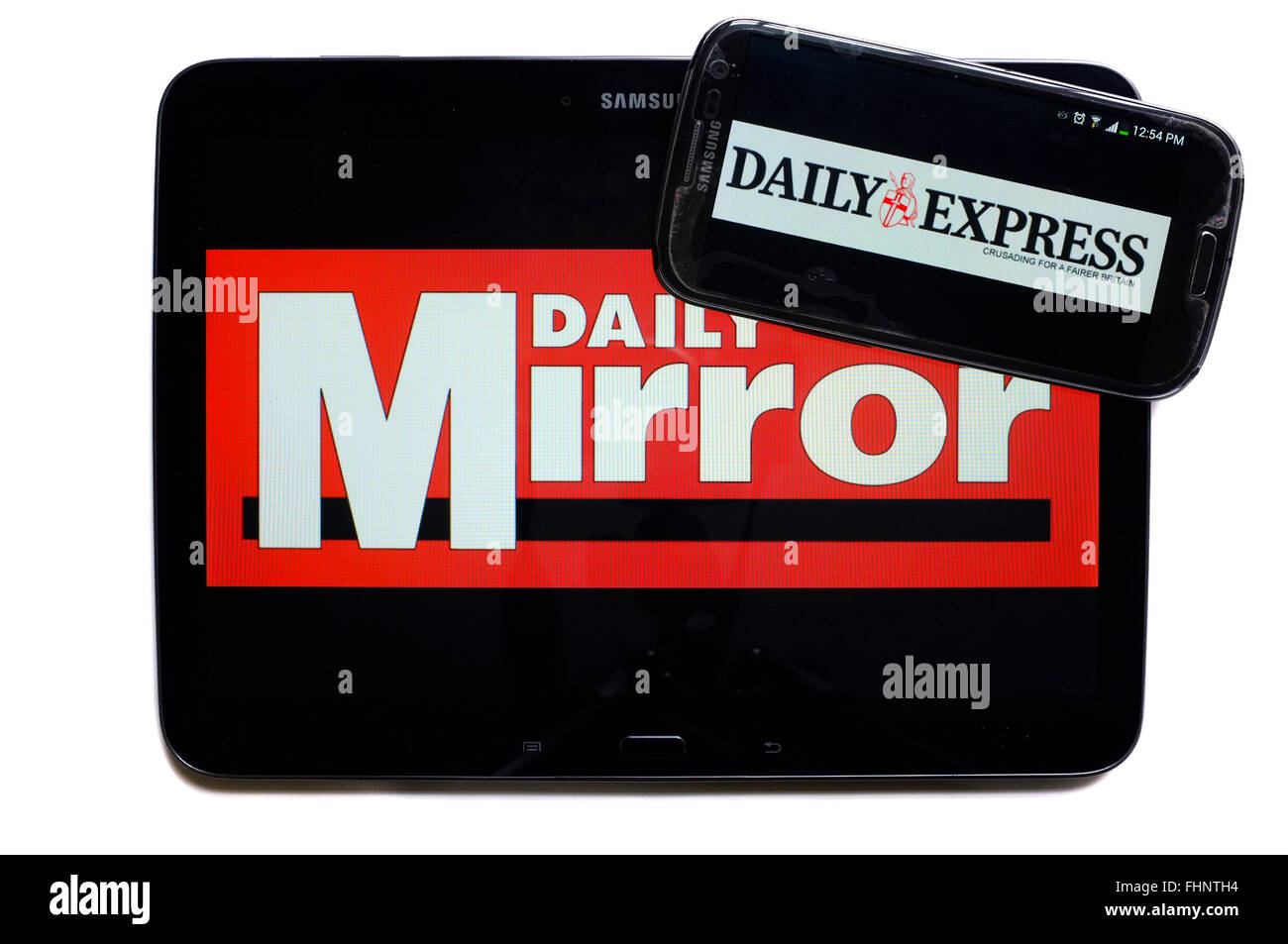 The logos of the Daily Mirror and the Daily Express newspapers displayed on the screens of a tablet and a smartphone. Stock Photo