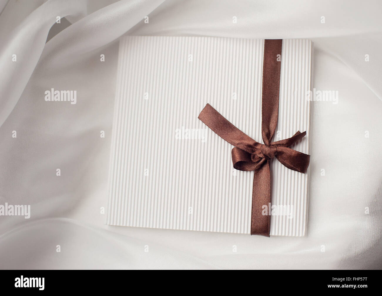 white envelope brown ribbon with a bow and place for text Stock Photo