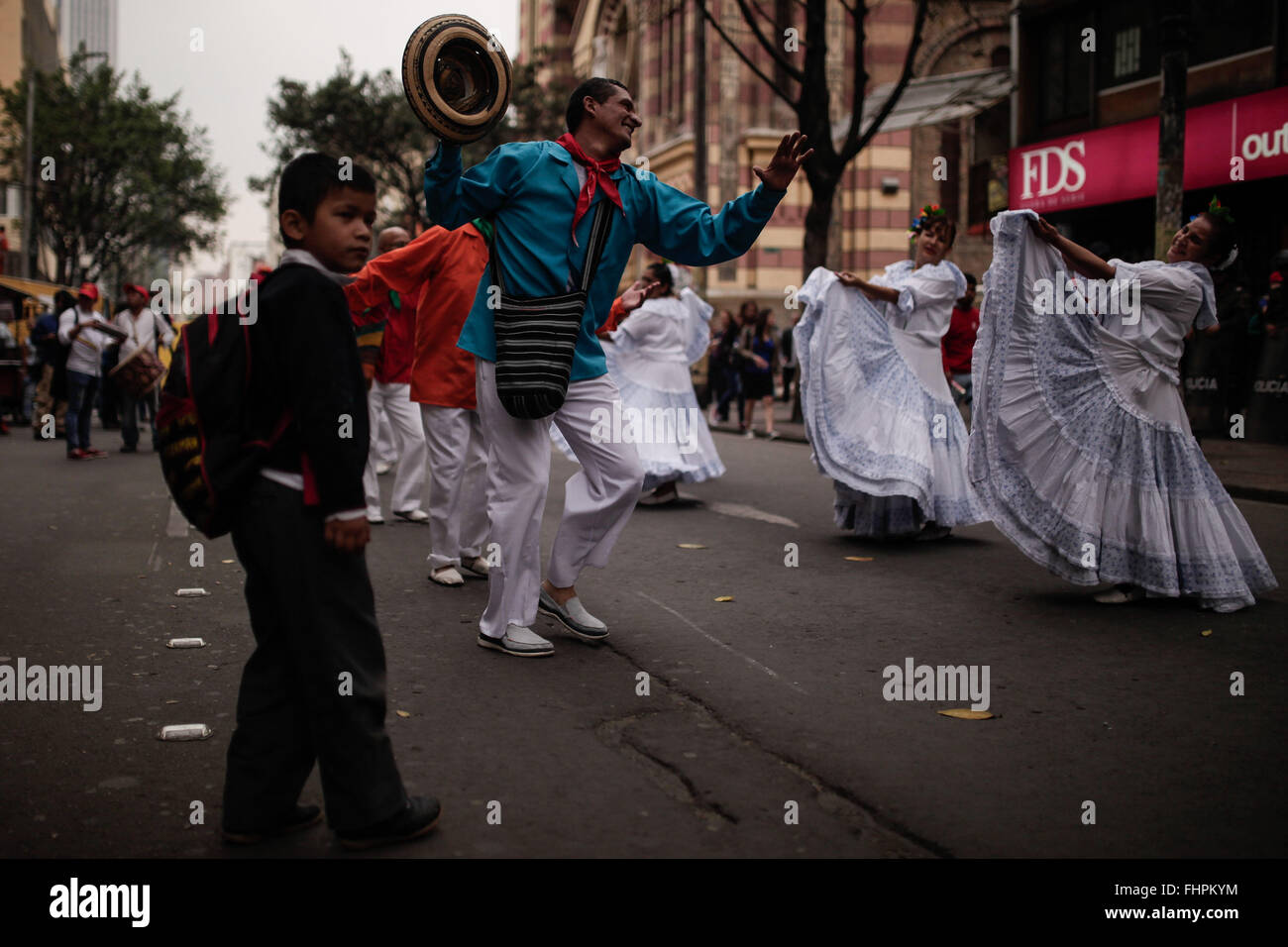 Bogota, Colombia. 25th Feb, 2016. Residents dance during a march called by student organizations and labor unions, in Bogota, capital of Colombia, on Feb. 25, 2016. Hundreds of citizens, students and leaders of labor unions demonstrated against the value-added tax increase, the low increase to minimum wage, the mishandling of higher education and the sale of national companies. © Jhon Paz/Xinhua/Alamy Live News Stock Photo