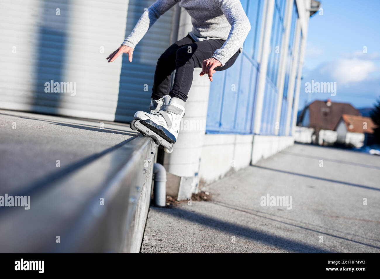 Low section of young man doing a trick on inline skates Stock Photo